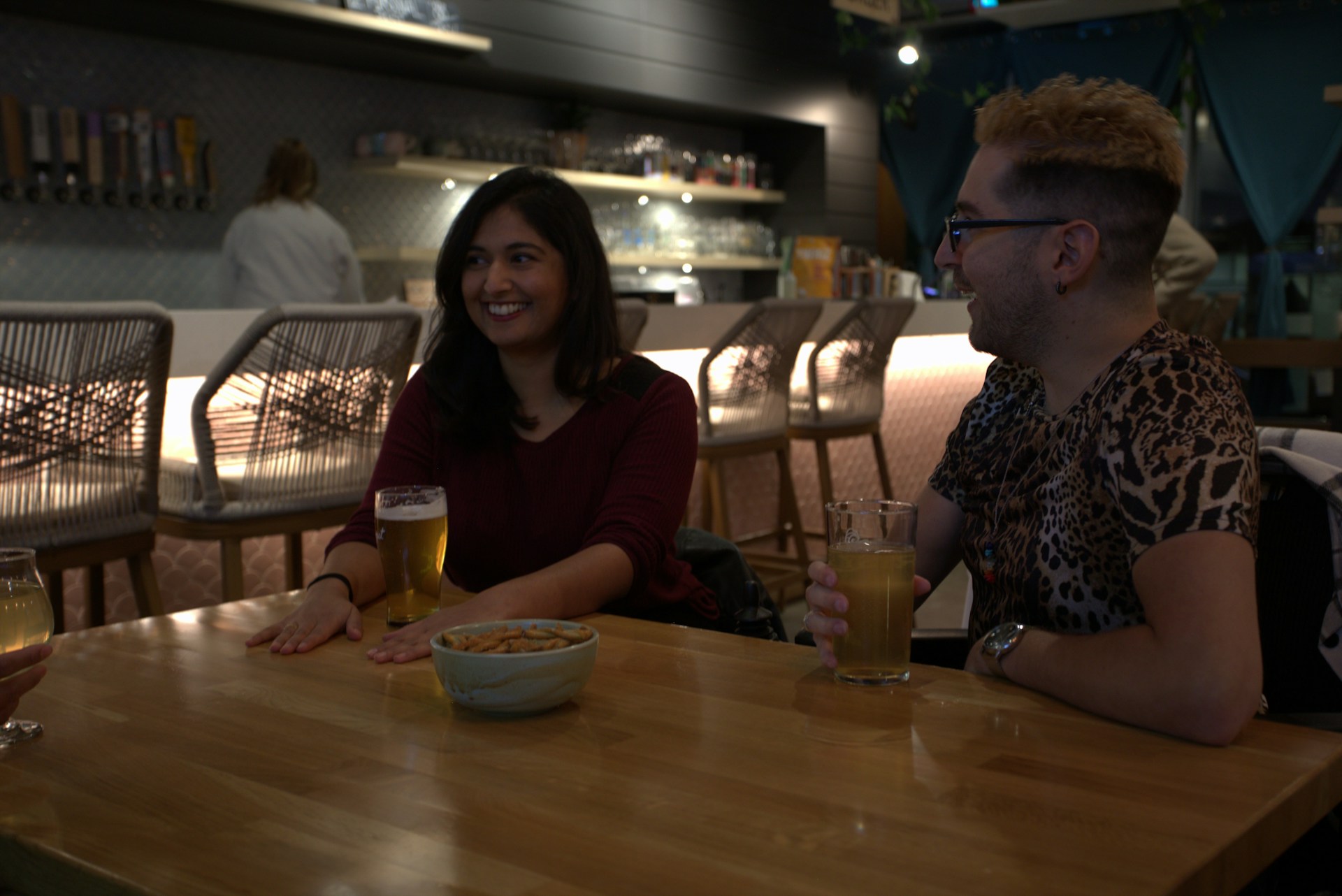 Participants chatting informally with drinks after the event.