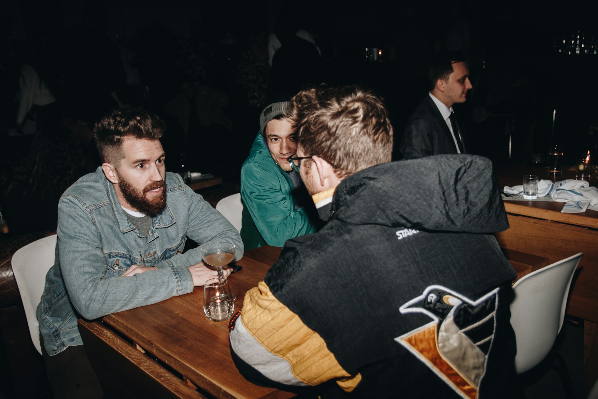 Four people engaged in a focused, structured debate around a table.